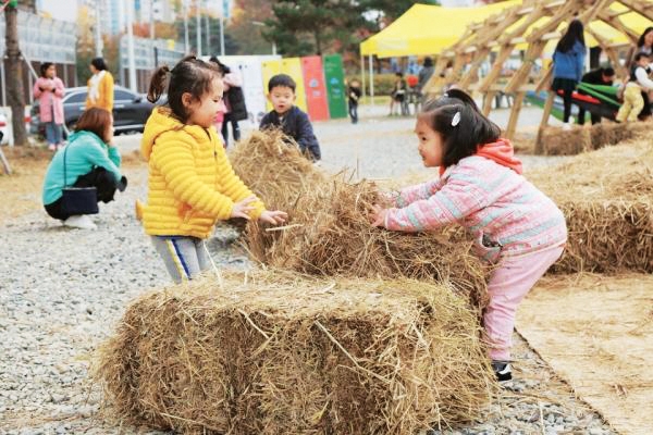 지난해 11월 ‘팝업 놀이터’에서 짚단을 옮기며 놀고 있는 어린이들. 사진 제공=춘천사회혁신센터